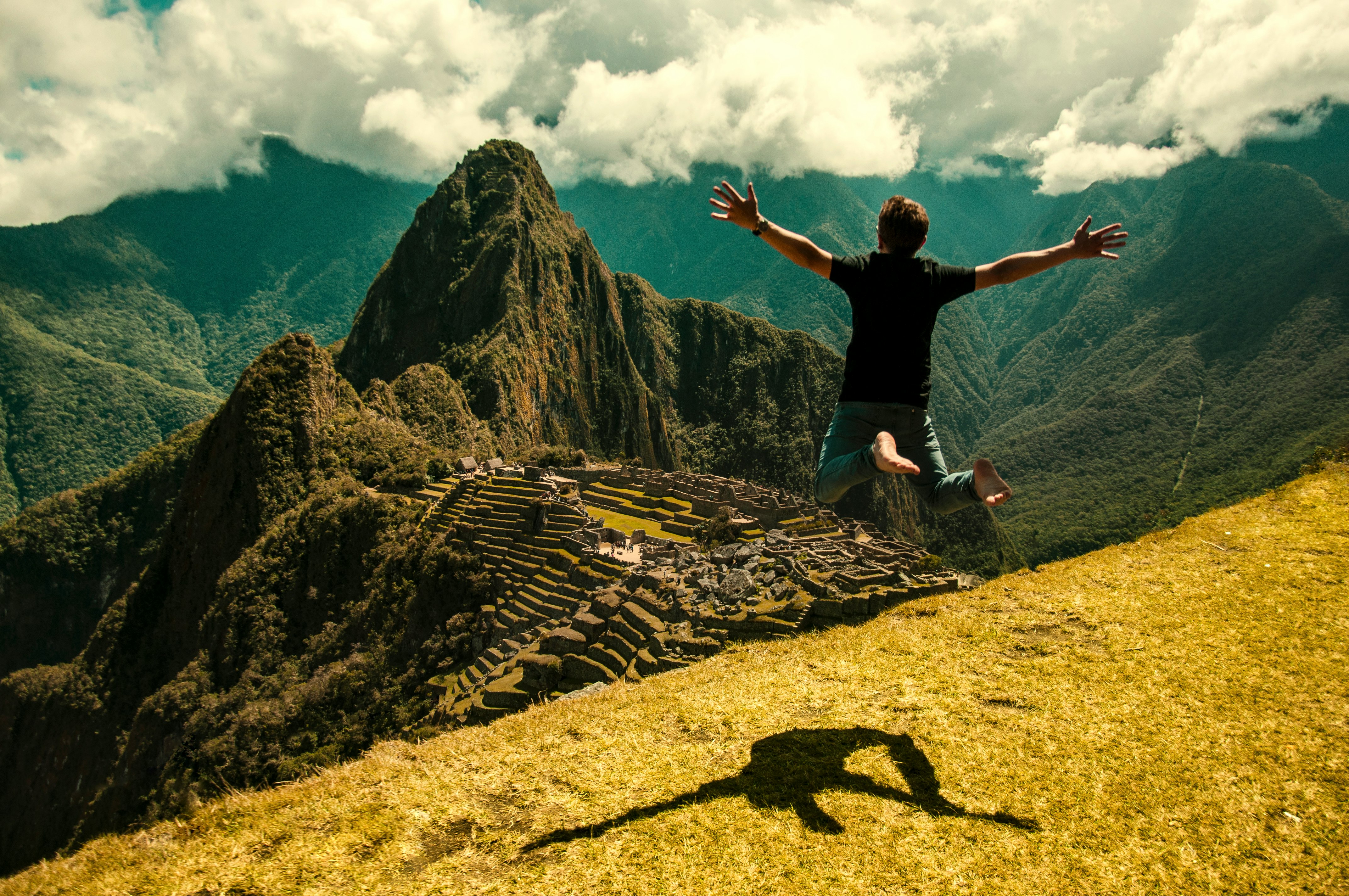 man jumping in green open field